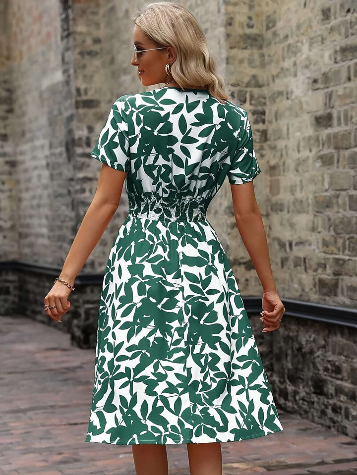 Side view of a women's smocked midi dress, highlighting the floral print and comfortable, casual fit.