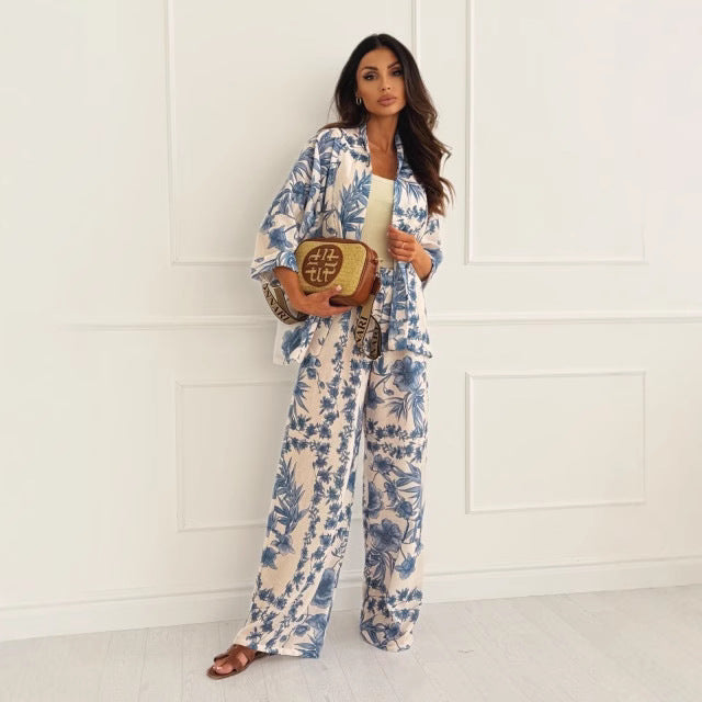 Elegant women's floral long sleeve top paired with flowy wide-leg pants. A fashionable two-piece spring/summer outfit.