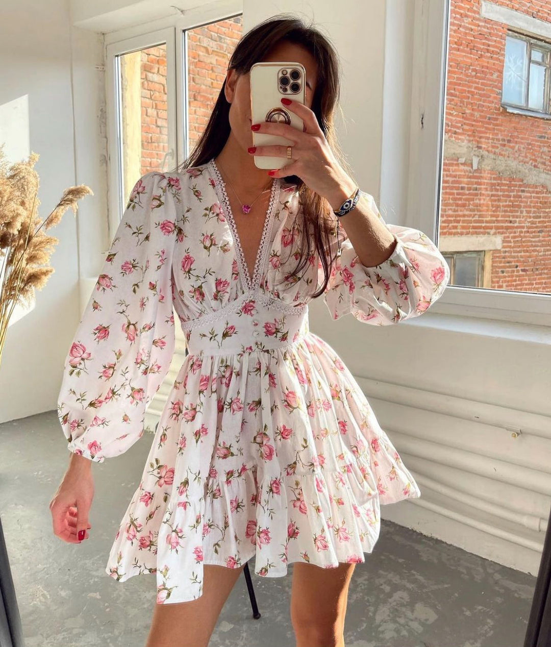 Women's floral V-neck mini dress with long balloon sleeves & tiered skirt, perfect for summer parties.