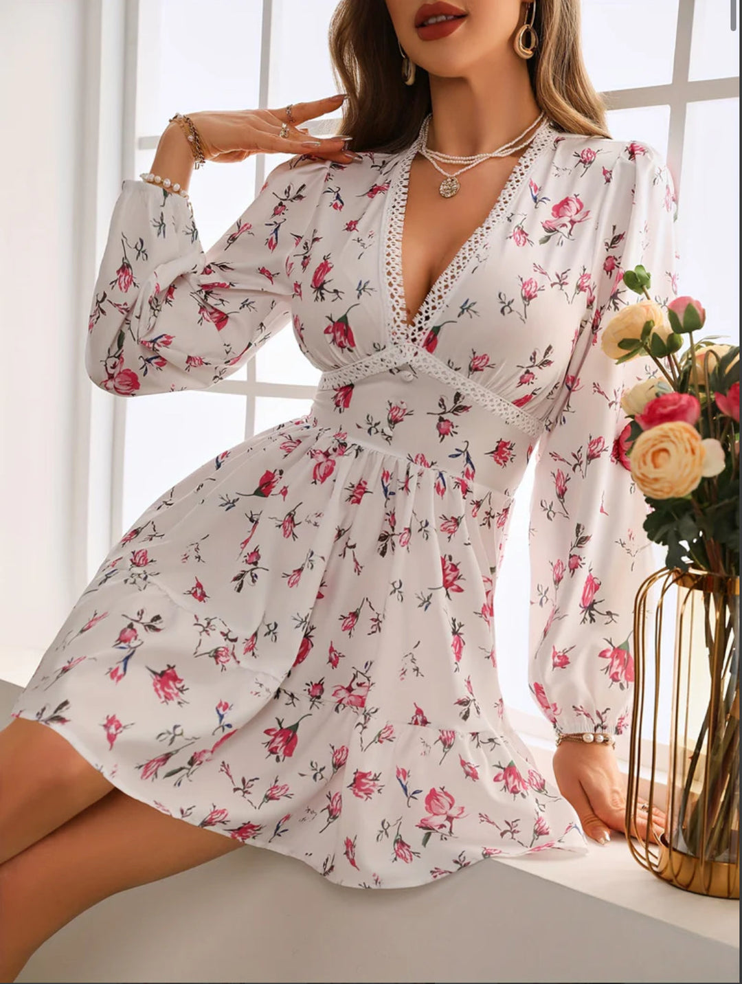Stylish floral V-neck mini dress for women, featuring long balloon sleeves & a tiered skirt. Great for casual chic.