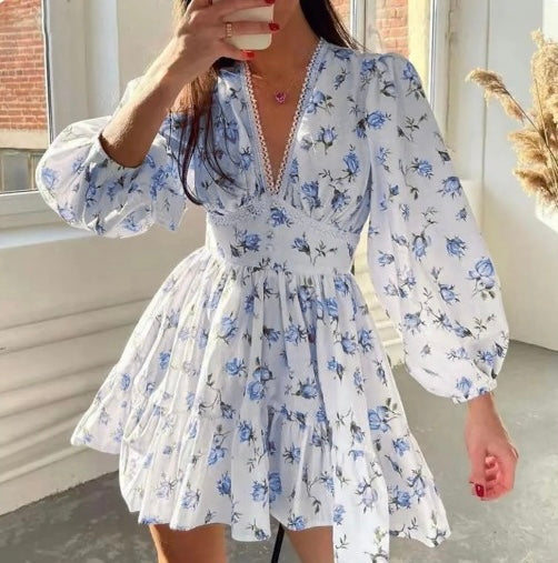 Boho-inspired women's floral long-sleeve mini dress. V-neck, tiered skirt, ideal for summer parties & casual chic.