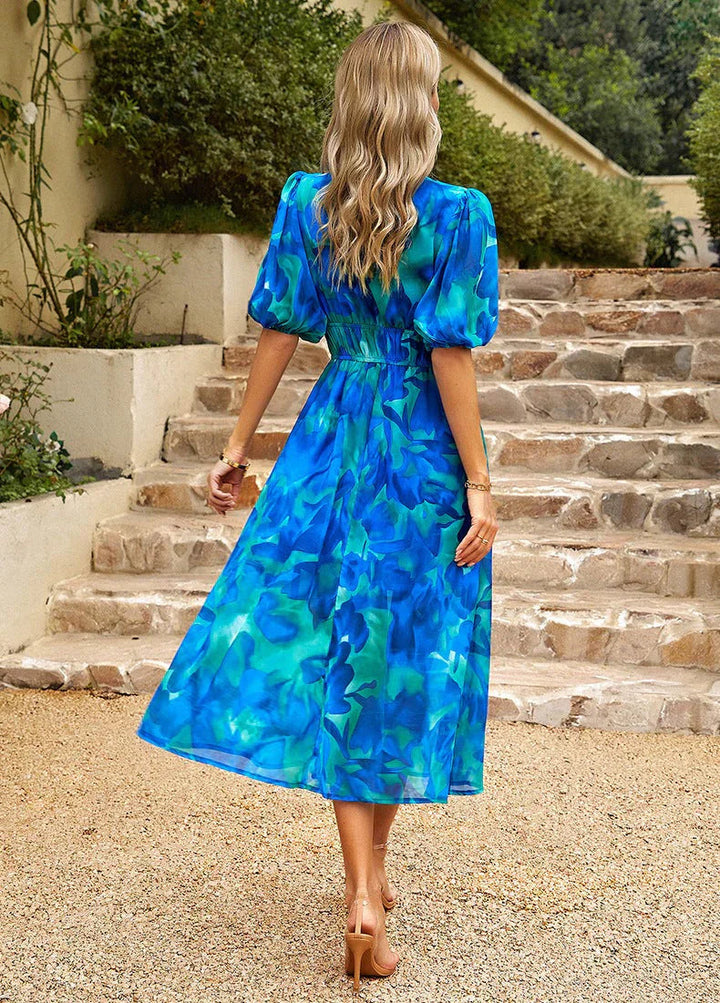 Beautiful women's floral print midi dress featuring a flowing silhouette and delicate puff sleeves for effortless elegance.