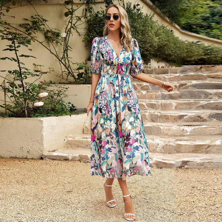 Stylish women's summer midi dress with a beautiful floral print, puff sleeves, and a flattering cut for elegance.