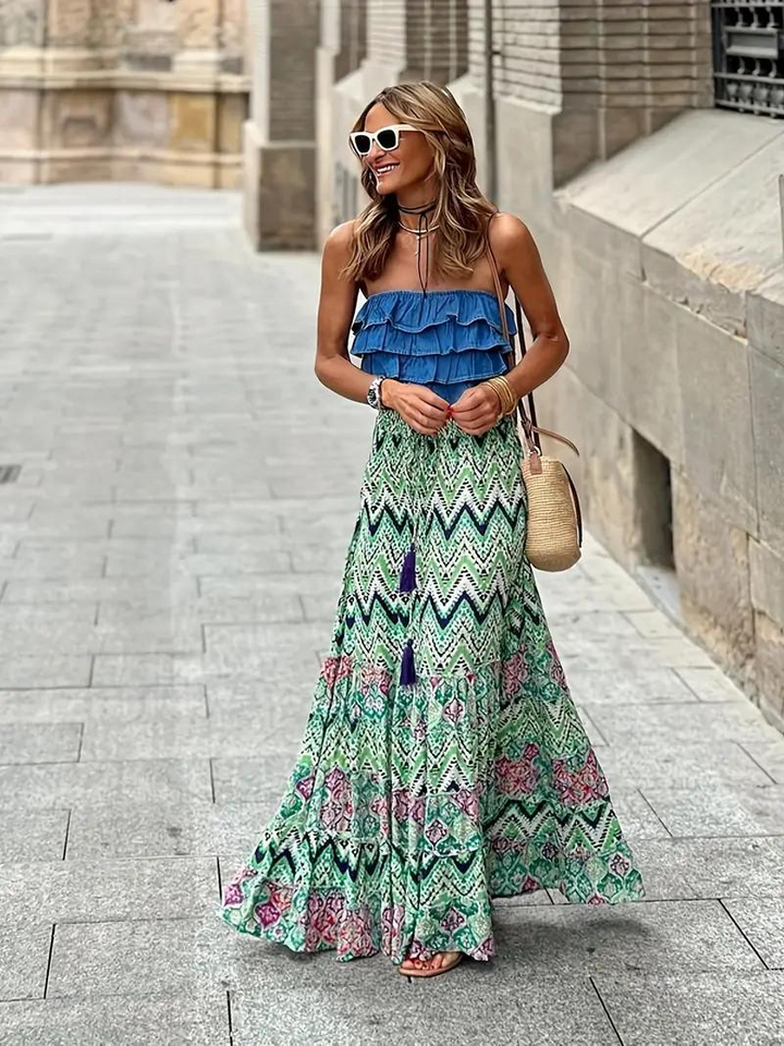 Women's flowing tiered boho maxi skirt in a vibrant print, ideal for elegant summer style.