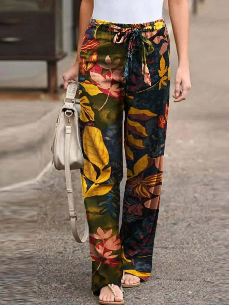 Effortless summer fashion: woman in vibrant floral wide-leg pants. Flowy, comfortable & casual style.