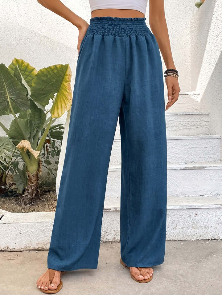 Navy blue flowy high-waisted wide-leg pants. Comfortable, loose fit, ideal for summer fashion & spring style.
