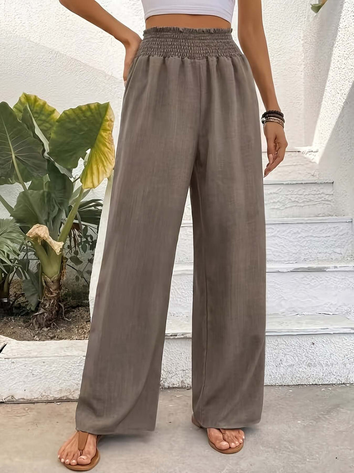 Lightweight polyester blend flowy wide-leg pants with a high waist for chic, versatile summer & spring fashion.