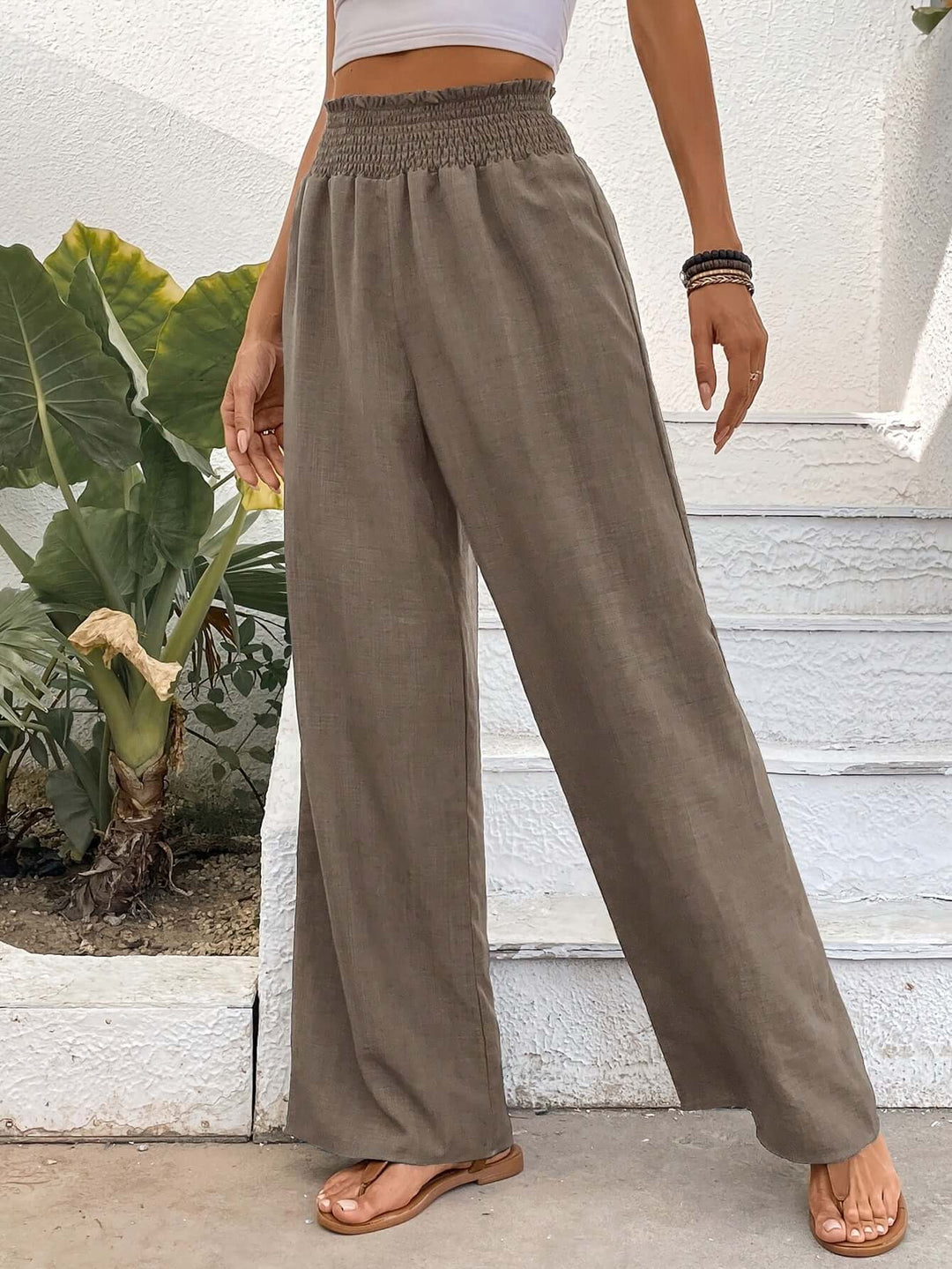 Women's high-waisted flowy wide-leg pants. Comfortable, loose fit, great for casual spring/summer fashion.