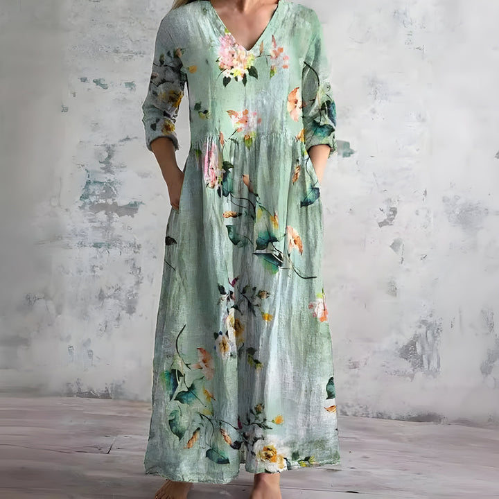 Vibrant floral print women's maxi dress. Flowy V-neck design, ideal for summer casual & beach.