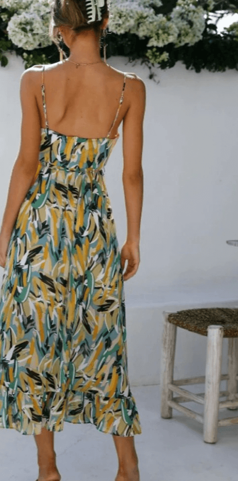Elegant flowy V-neck midi dress for women, featuring spaghetti straps and a soft fabric, suitable for evening wear.