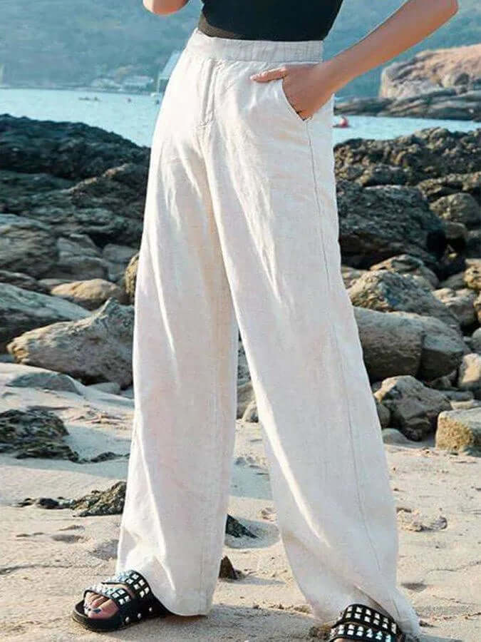Apricot yellow women's wide-leg linen pants. Effortless, breathable summer fashion & resort wear.