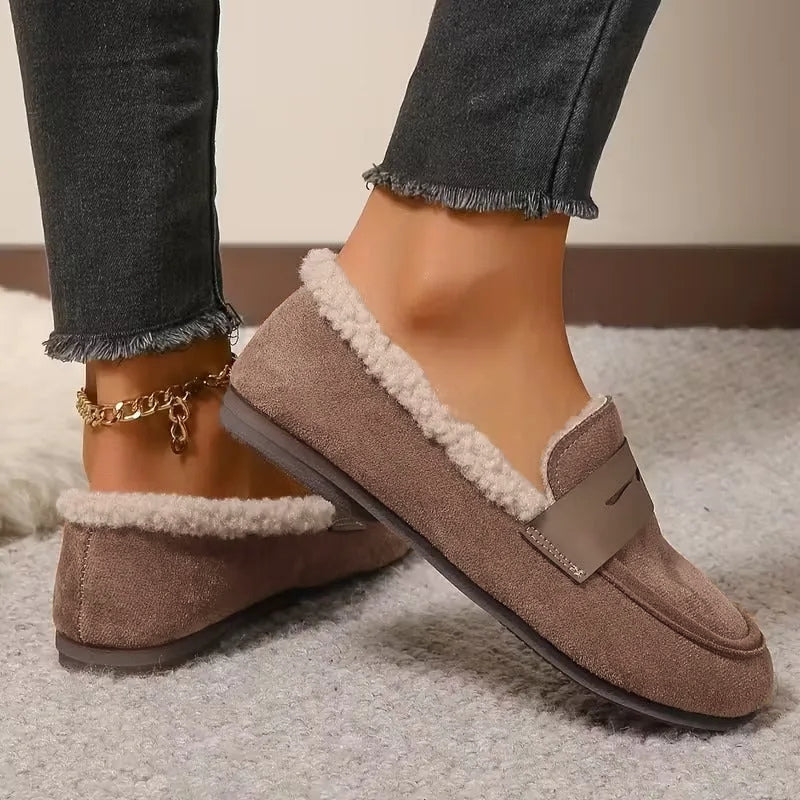 Comfortable women's slip-on penny loafers with soft fluffy lining, great for winter outings.