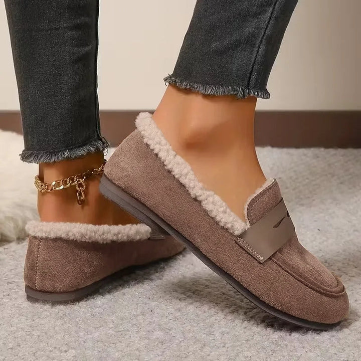 Comfortable women's slip-on penny loafers with soft fluffy lining, great for winter outings.