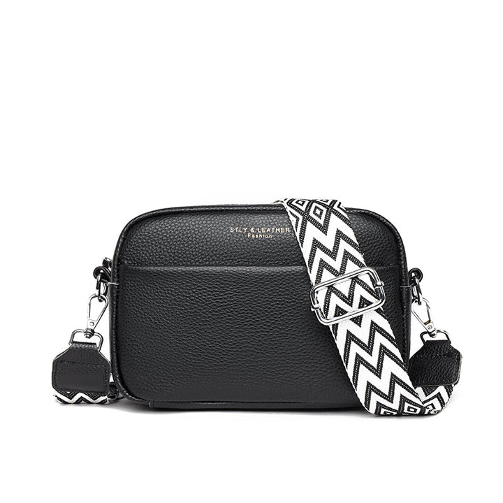 Women's genuine pebbled leather crossbody bag with adjustable strap, a stylish everyday fashion accessory.