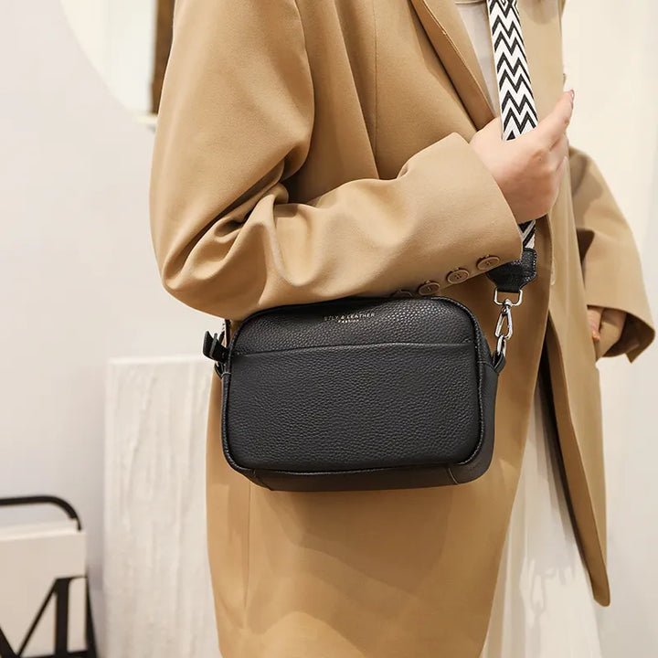 Detail of genuine pebbled leather on a women's versatile crossbody shoulder bag, perfect for everyday.