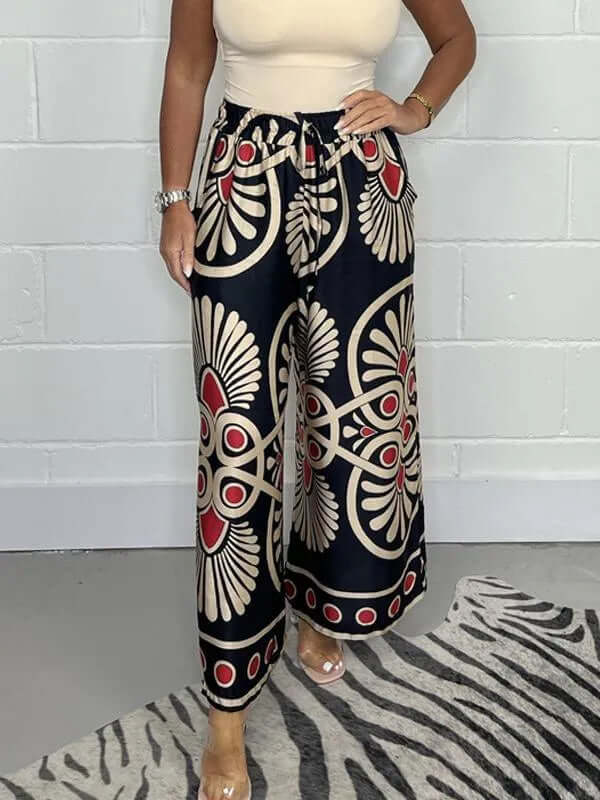 Stylish women's wide-leg palazzo pants with bold geometric print, featuring comfortable elastic waist.