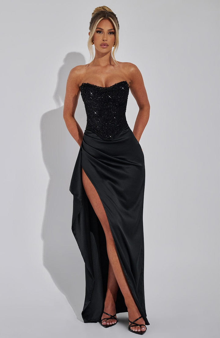 Glamorous women's black maxi dress with a beaded corset bodice & flowing skirt. Ideal for evening wear.