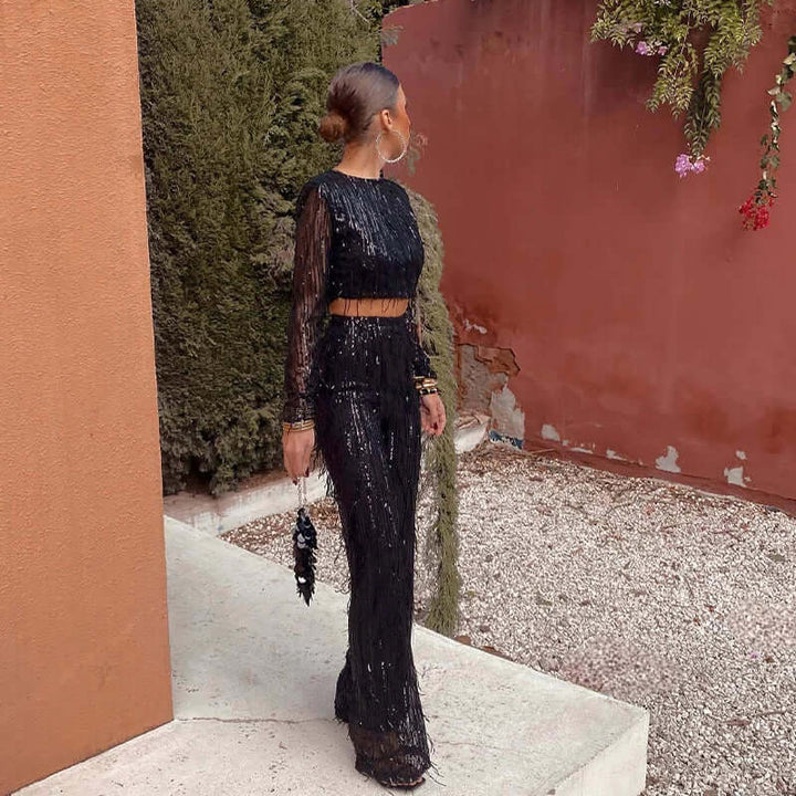 Dazzling women's sequin crop top and high-waisted trousers two-piece, a glamorous party outfit.