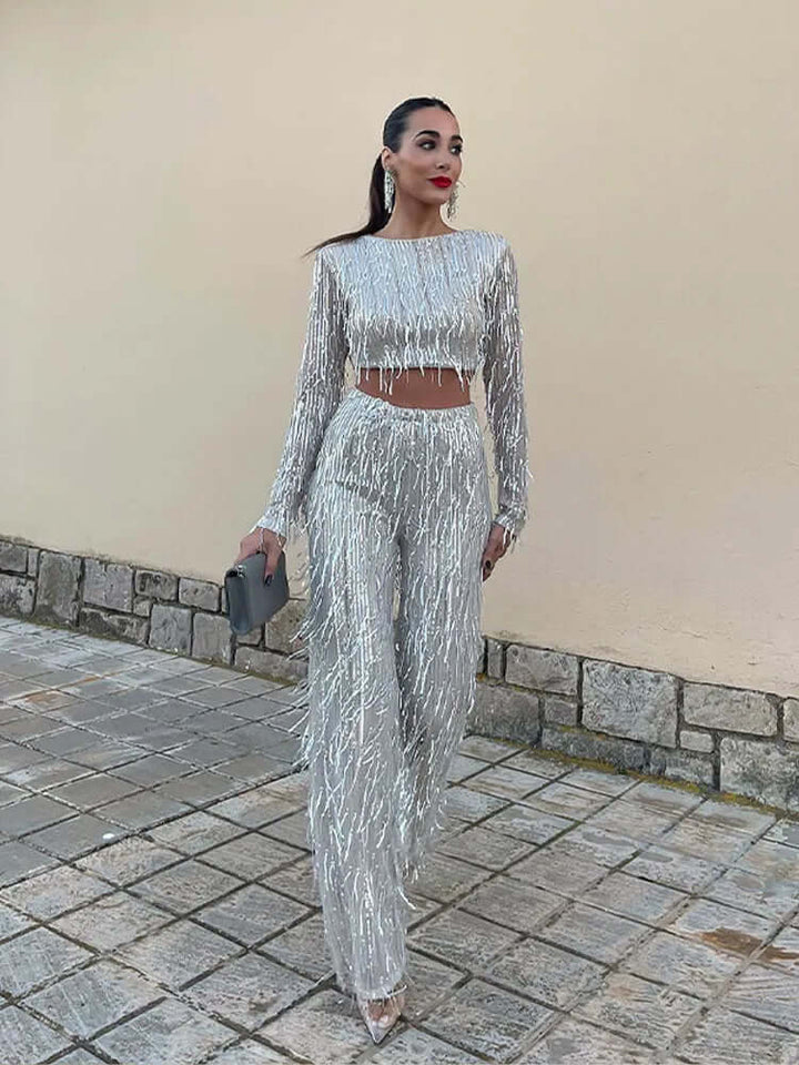 Fashionable women's sequin crop top & high-waisted trousers set, perfect for special occasions.