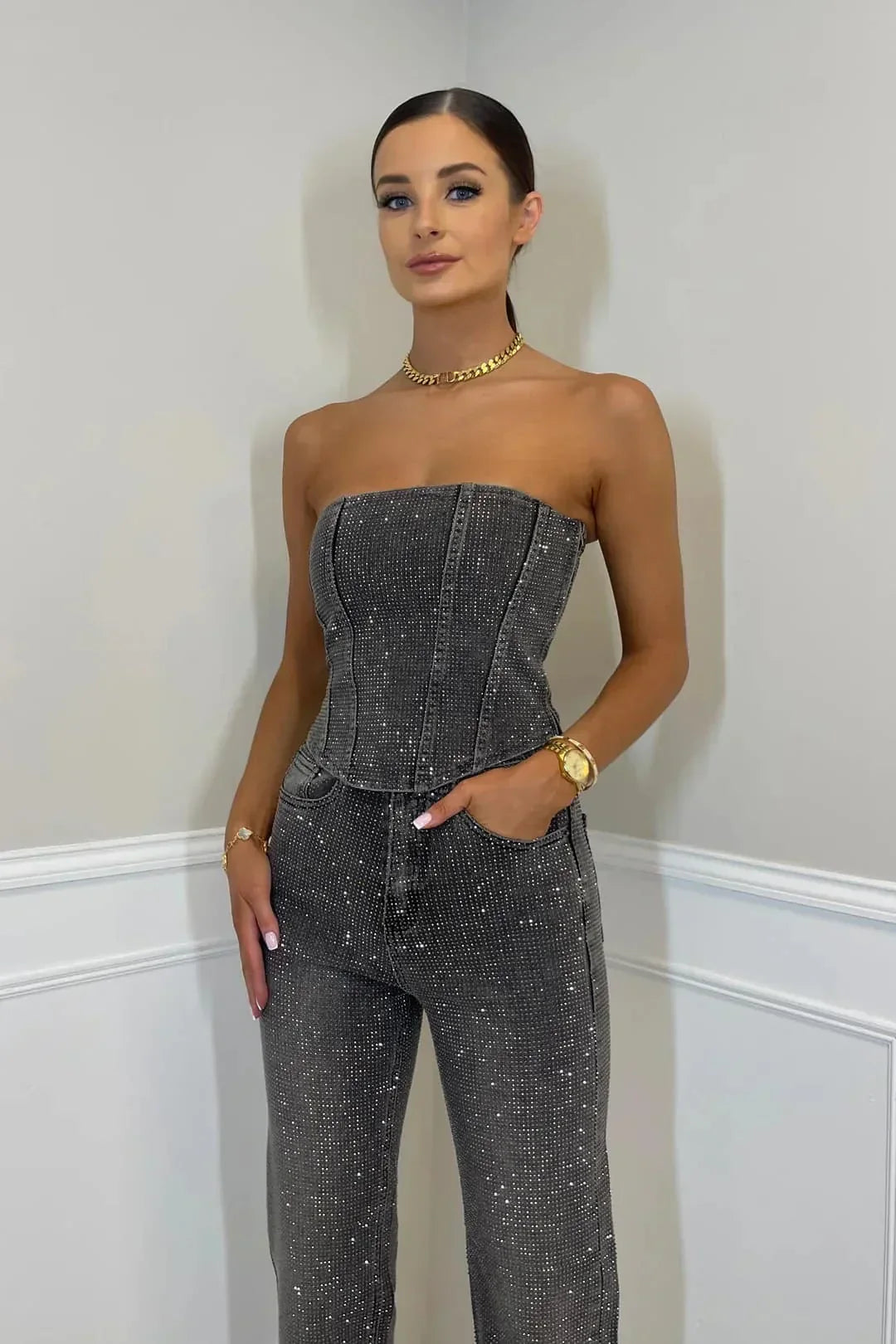 Stylish women's glittering high-waist trousers and shimmering top set, perfect for special events.