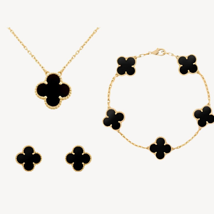 Colorful women's gold-tone clover jewelry set, a fashionable lucky charm necklace, bracelet, & earrings.