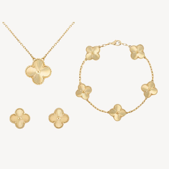 Elegant women's gold-tone clover necklace, bracelet, and earrings set. Perfect gift for her, available in colors.