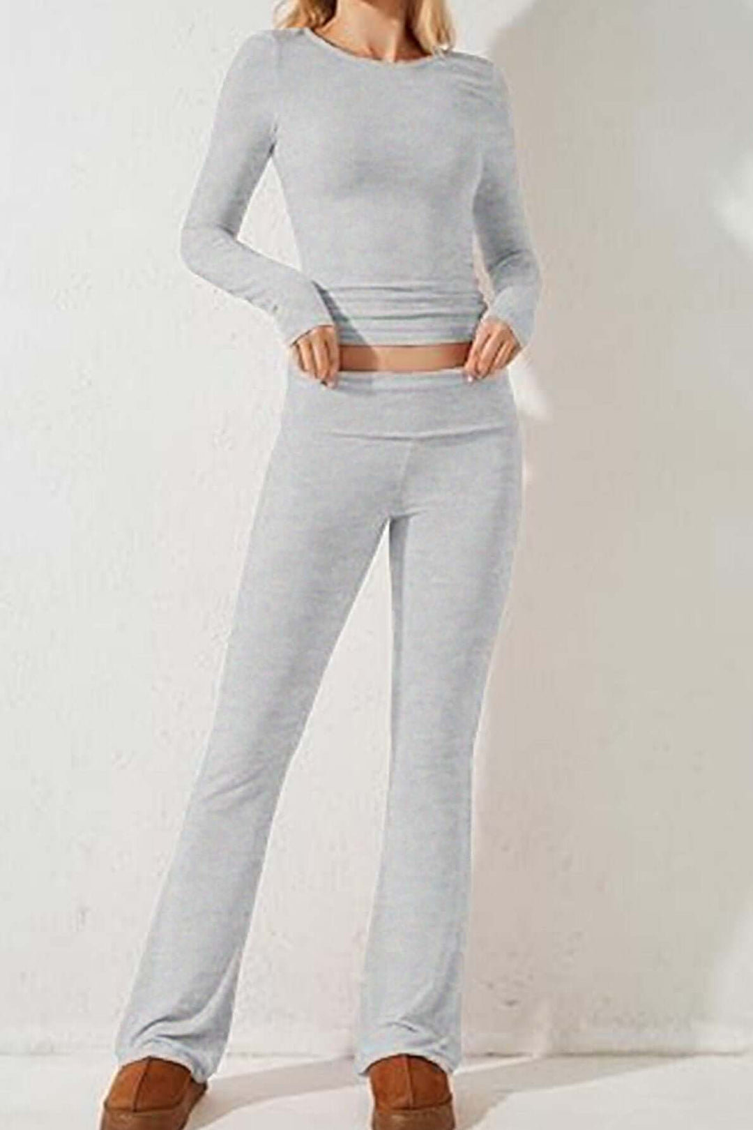 Comfortable gray knit loungewear set for women, including a soft long-sleeve top & relaxed flared pants.