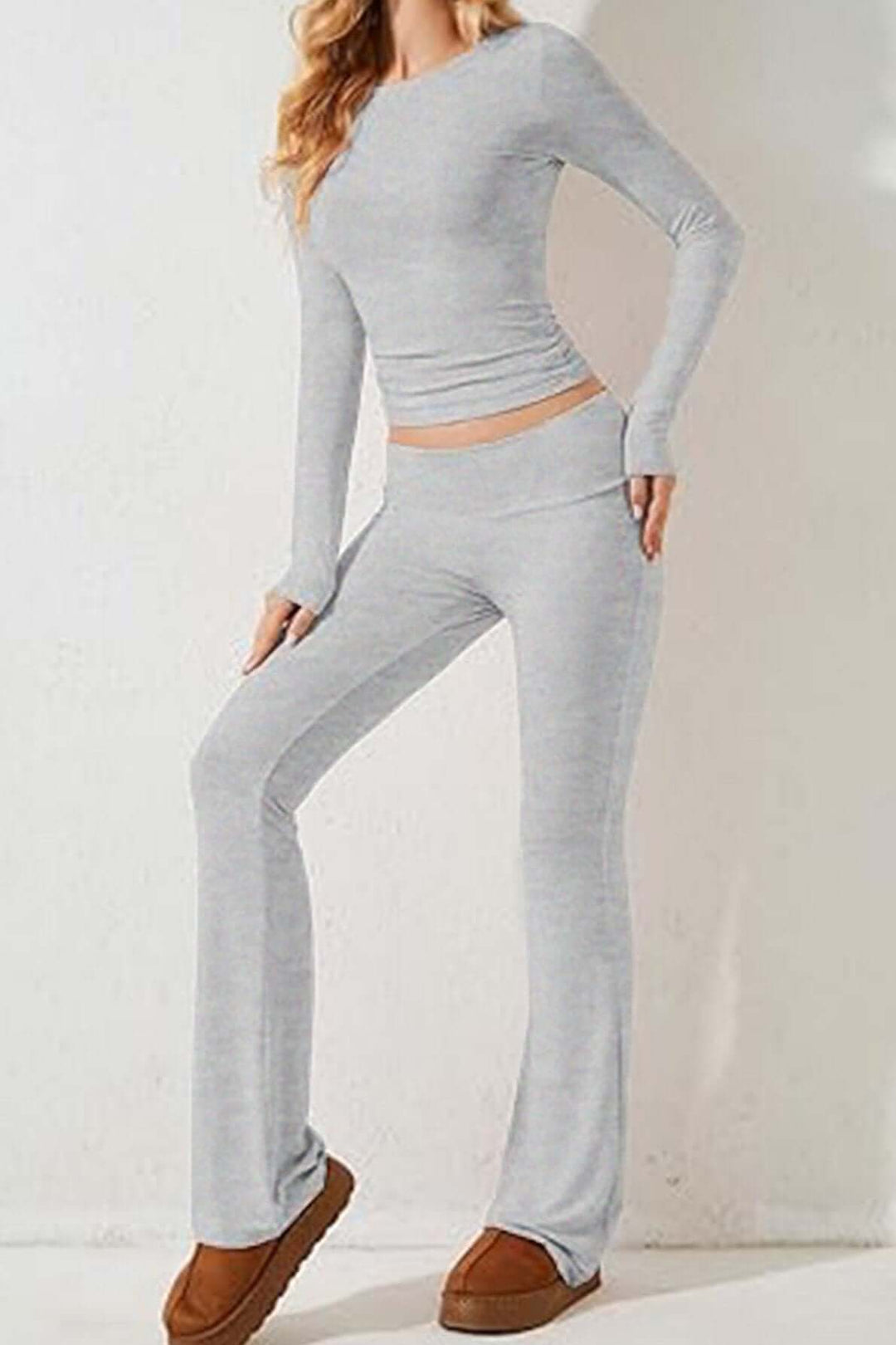 Fashionable women's gray knit loungewear set with long-sleeve top & flared pants for ultimate comfort & style.