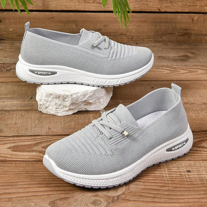 Stylish gray slip-on sneakers for women providing arch support and wide toe box