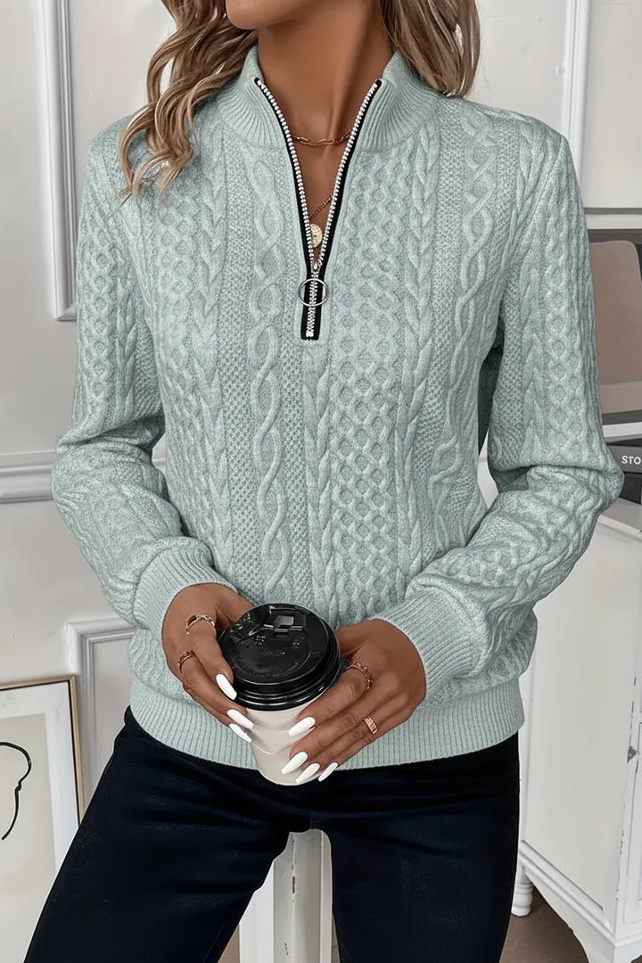 Women's half-zip ribbed hem sweater with ring pull. Combines comfort & modern style.