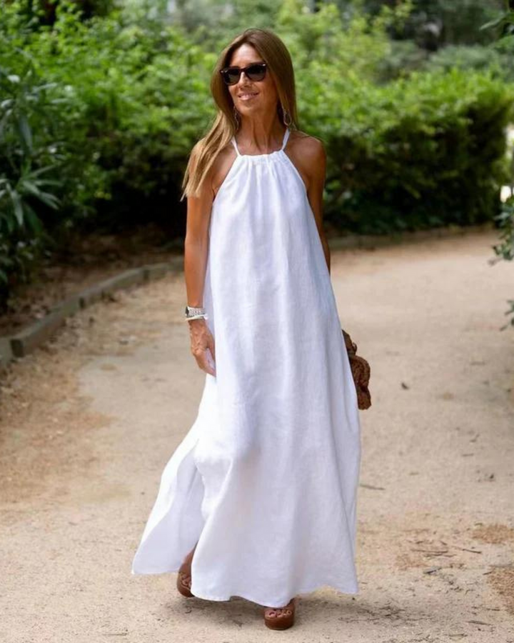 Elegant women's halter neck summer maxi dress, featuring a flowing silhouette suitable for casual resort wear.