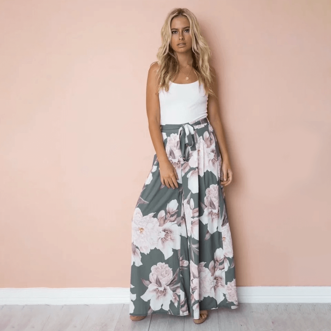 Comfortable polyester high waist women's pants with a vibrant floral print, ideal for a relaxed casual look.