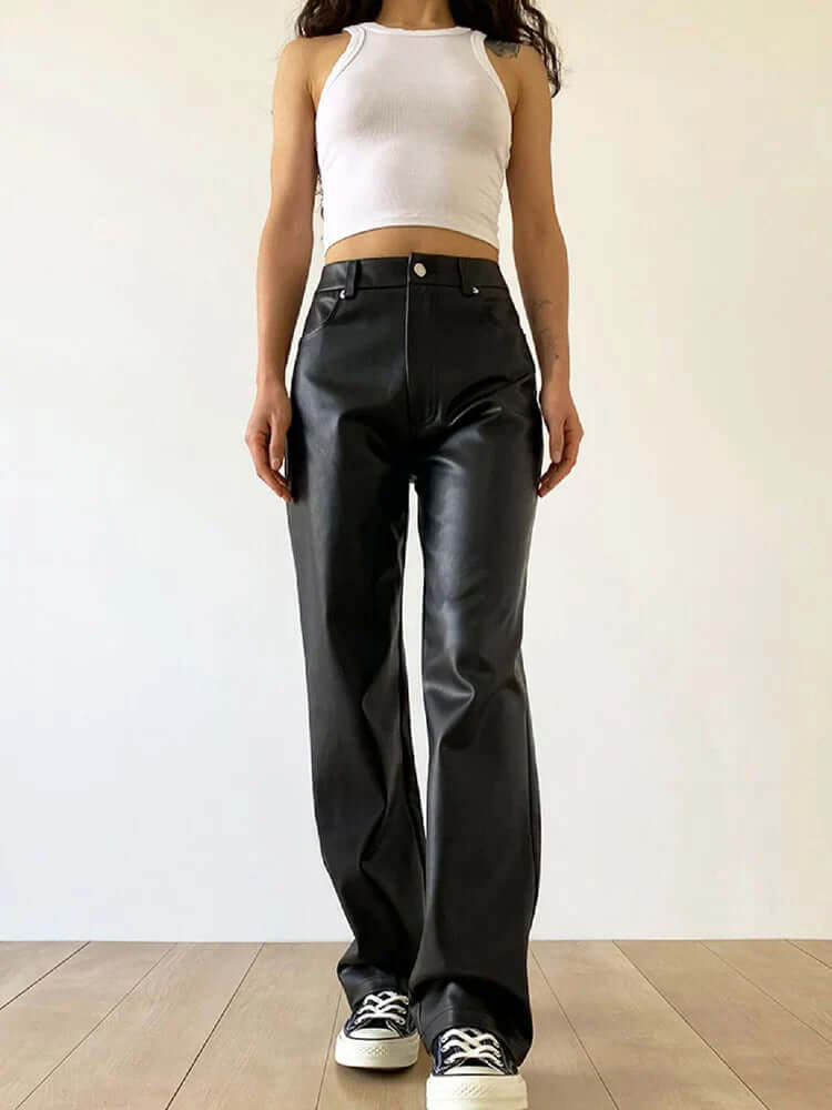 Woman wearing stylish high-waist straight-leg black leather pants, vintage-inspired for a chic look.