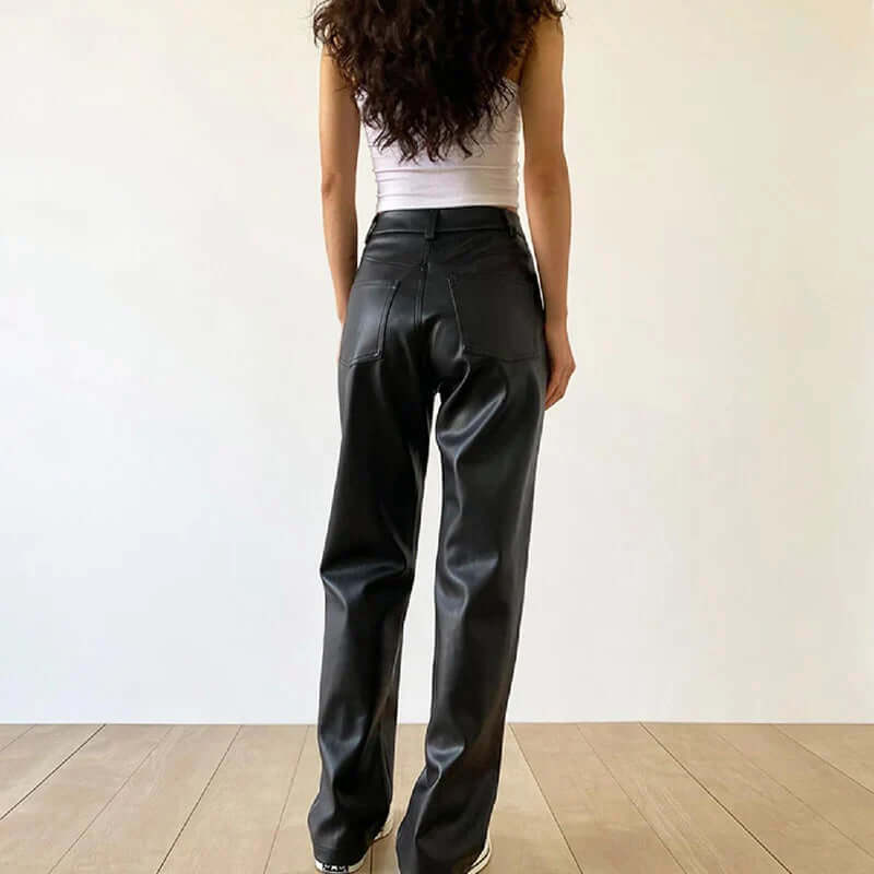 Sophisticated women's vintage black leather pants. High-waist and straight-leg design for elegant fashion.