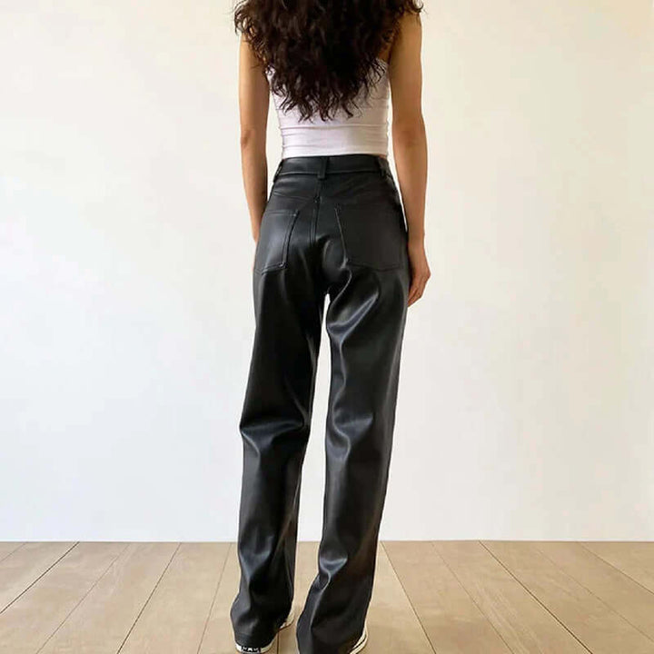 Sophisticated women's vintage black leather pants. High-waist and straight-leg design for elegant fashion.