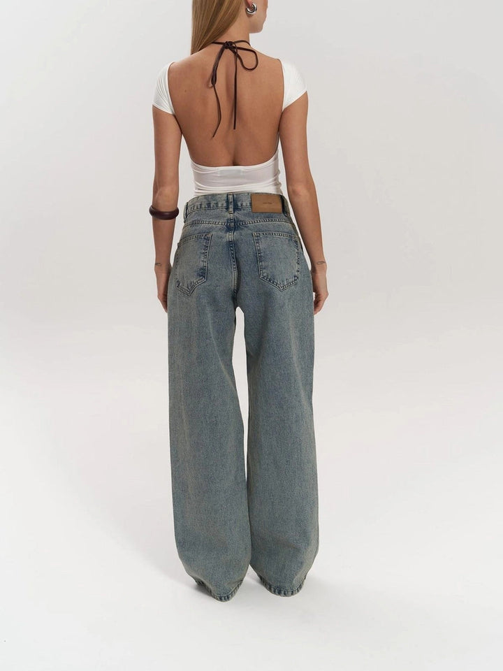 Statement women's wide leg jeans, high-waist design with unique panel detail. Indigo blue denim for modern fashion.