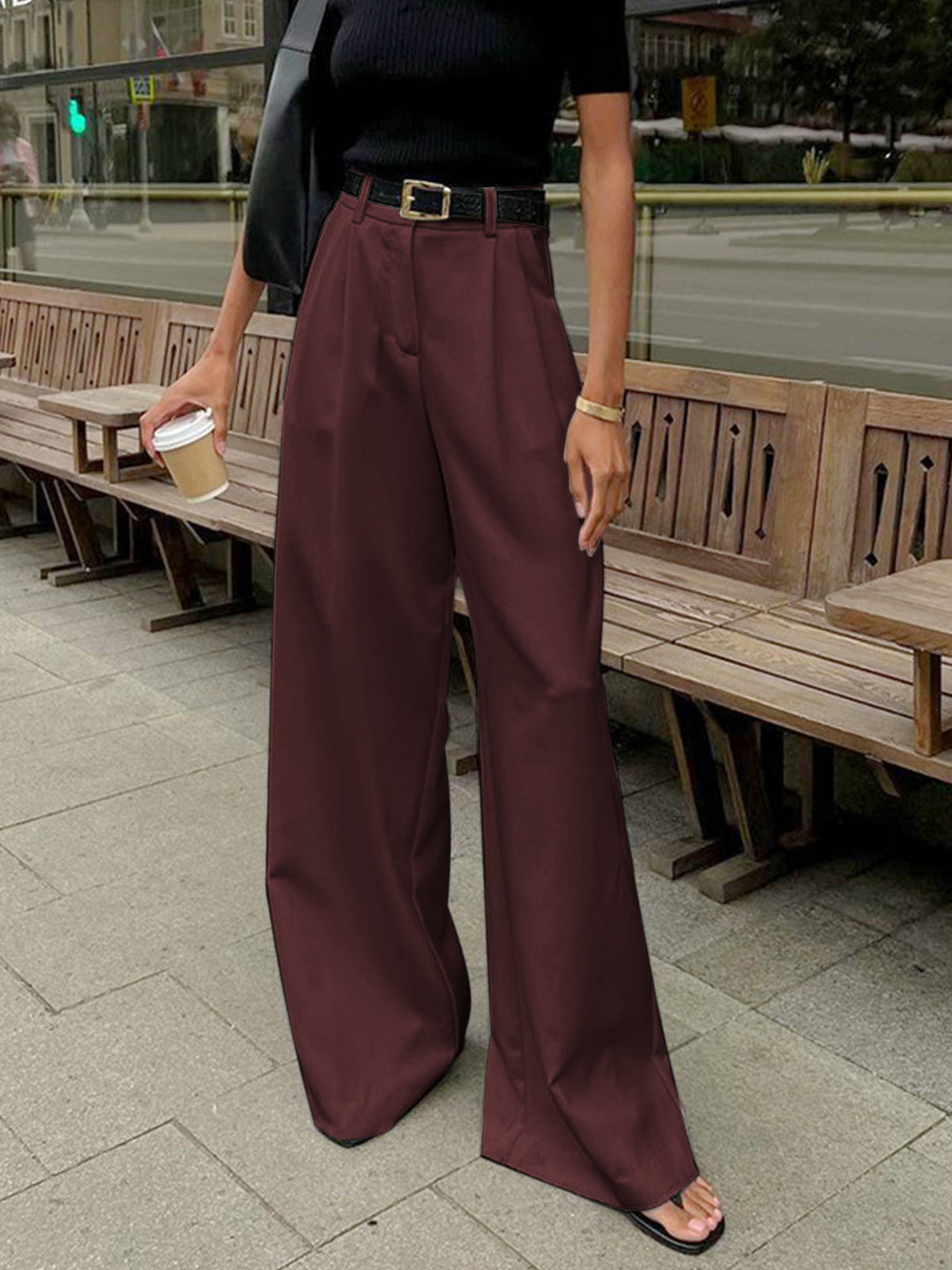 Close-up of women's tailored wide-leg trousers, detailing the high-waist and flowing fabric.