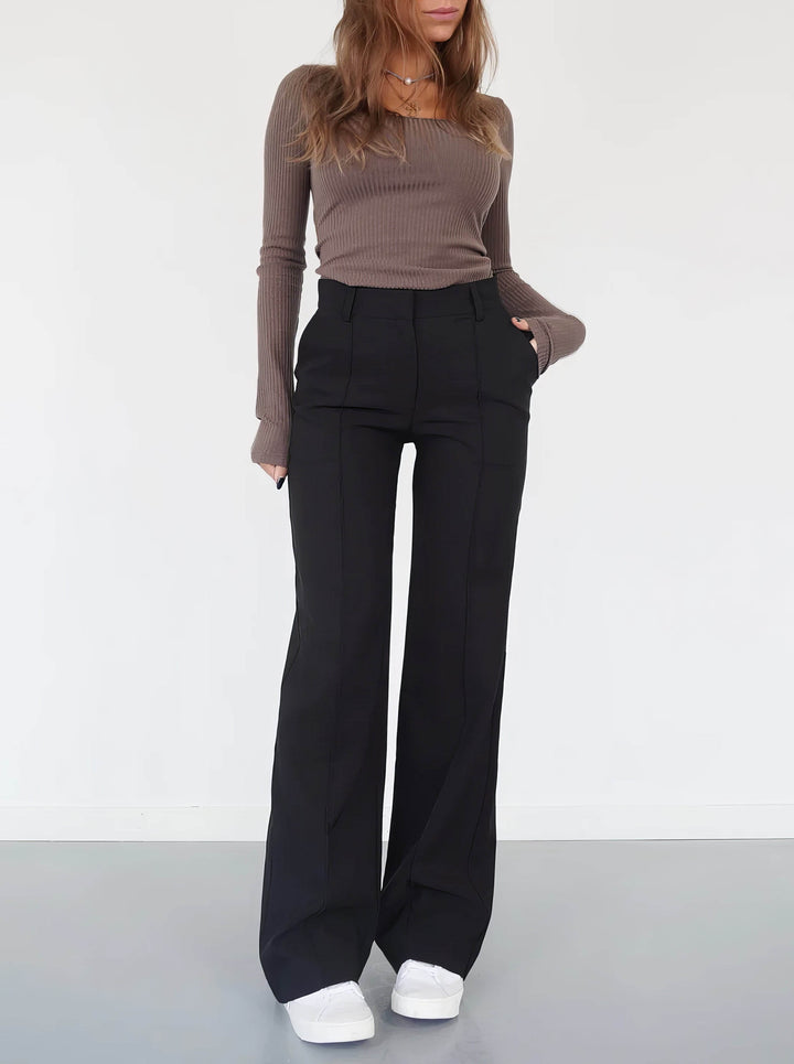 Women's high waist wide-leg trousers in a solid color, offering effortless style for casual or formal wear.