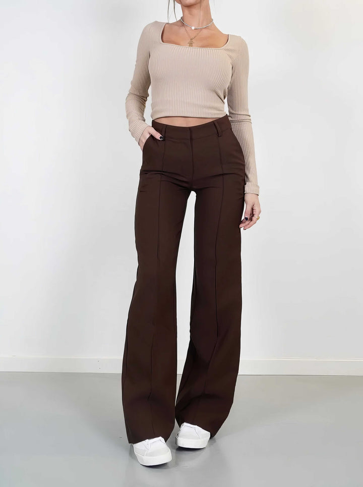 Stylish women's high-waisted wide-leg trousers, designed for a fashionable and comfortable fit. Solid color.