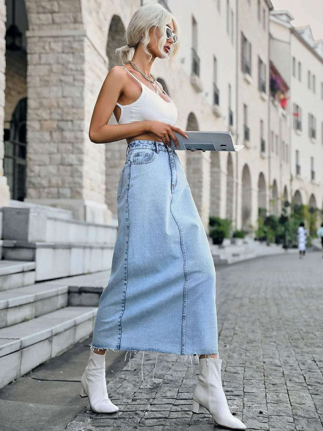 Long women's denim maxi skirt, high-waisted straight fit, with a chic frayed hem. Everyday fashion bottom.