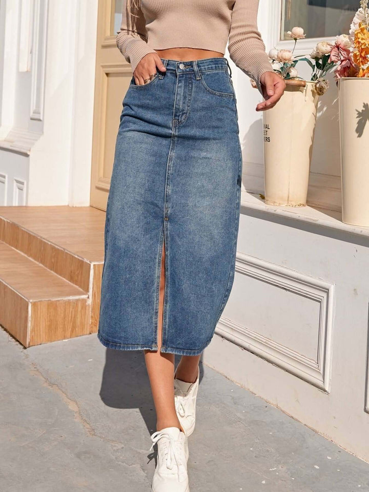 Casual blue denim midi skirt for women, featuring a flattering high-waisted fit and modern front slit.