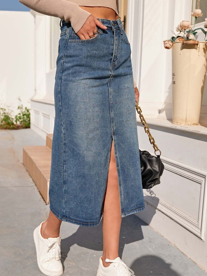 Fashionable high-waisted denim skirt with a midi length & elegant front slit, ideal for versatile styling.