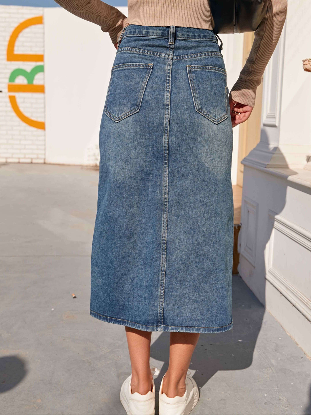 Everyday women's midi denim skirt in classic blue, designed with a comfortable high waist & front slit.