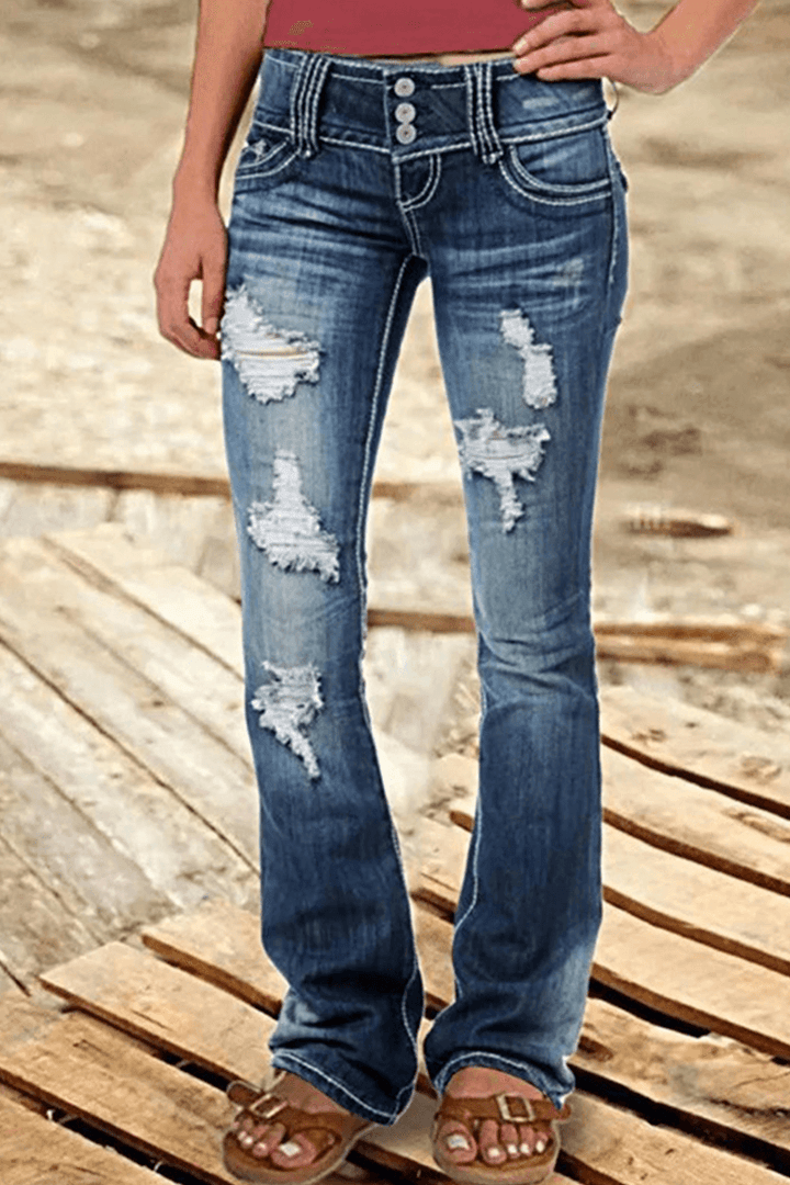 Stylish women's black ripped high-waisted bootcut jeans. Distressed denim fashion for a trendy casual outfit.