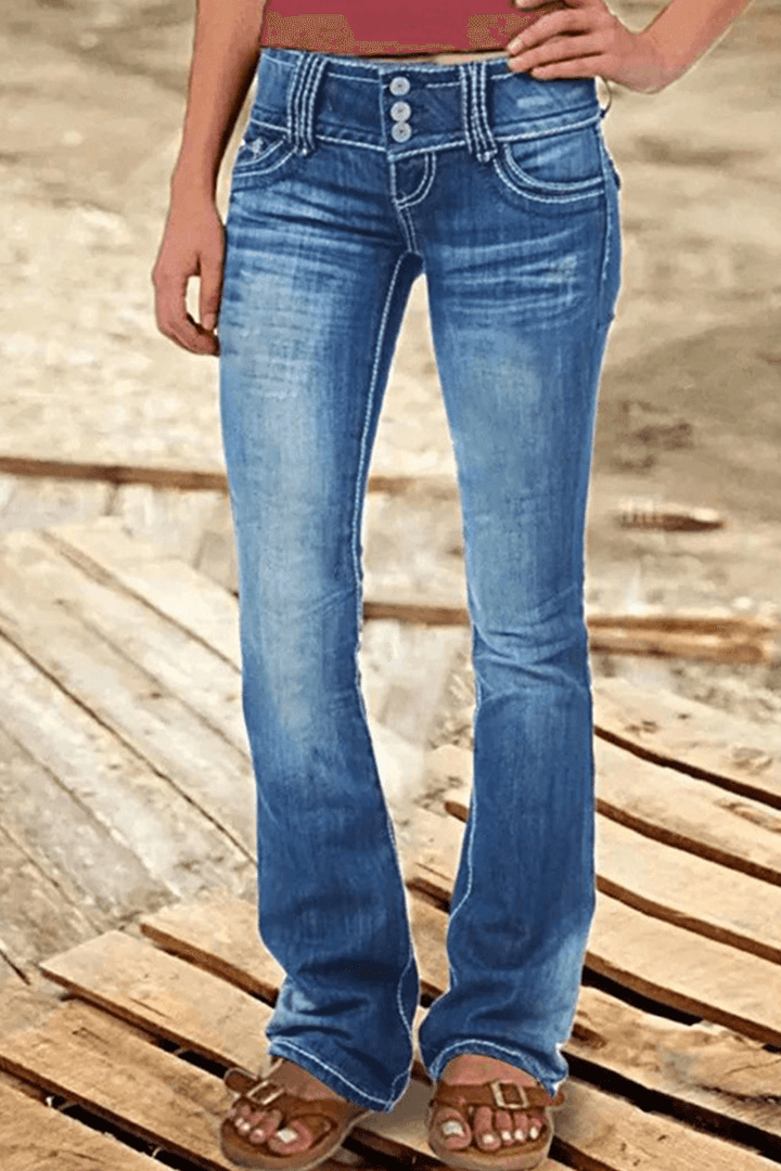 Trendy women's ripped high-waisted bootcut jeans in dark wash denim. Flattering fit for chic casual apparel.