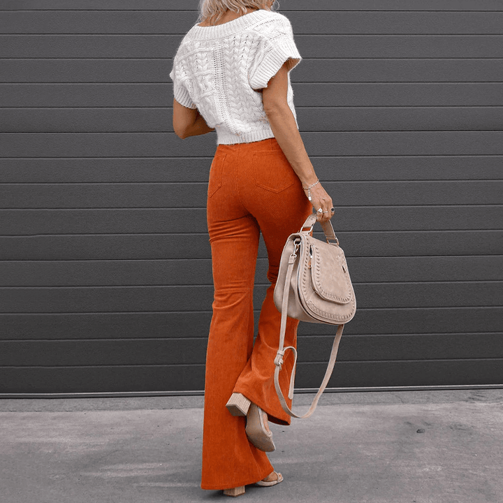 Comfortable women's high-waisted corduroy trousers with a wide leg flare, great for casual fall wear.