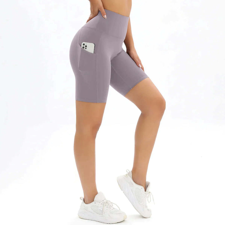 Women's high-waisted workout shorts with phone pocket, showcasing comfort and flexibility on a model.