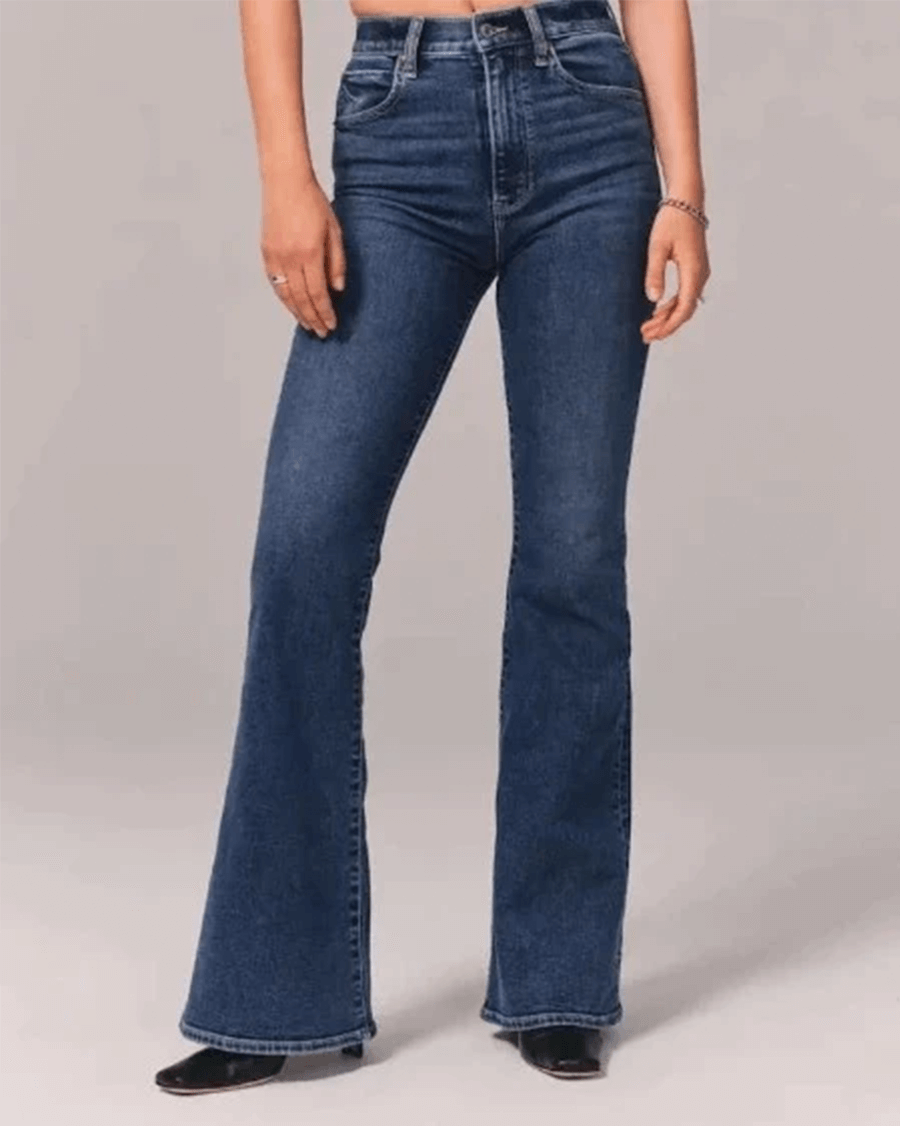 Stylish women's flared jeans with a high waist in blue stretch denim, perfect for a modern casual outfit.