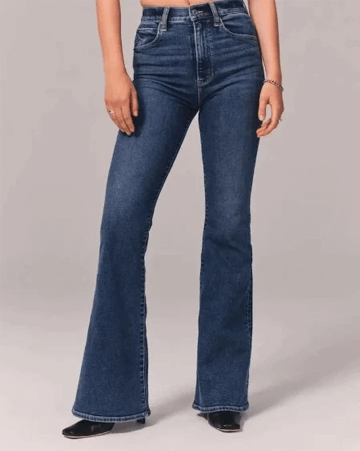 Stylish women's flared jeans with a high waist in blue stretch denim, perfect for a modern casual outfit.