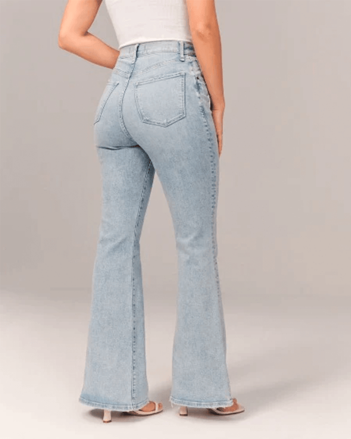 Blue stretch denim women's jeans with a high waist and stylish flare, offering comfort and vintage appeal.